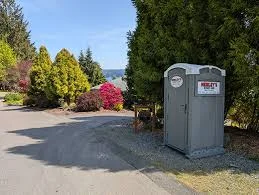 Line of standard portable toilets staged for dispatch at the Arizona Porta Potty yard.